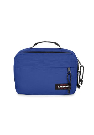 Blue fabric bag with a zip closure, top handle, and front pocket. Features black accents and a visible brand label. Rectangular shape.