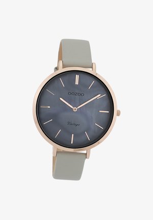 Roségoldene Uhr mit einem dunkelgrauen Perlmuttziffernblatt, minimalen Stundenmarkierungen und einem hellgrauen Silikonarmband. Verfügt über ein klassisches rundes Design.