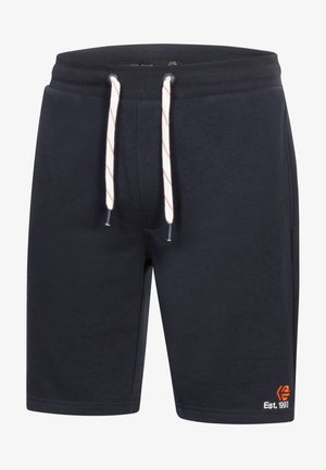 Námořnické modré šortky volného střihu vyrobené z měkké bavlny. mají bílé šnůrky s červenými akcenty a malé vyšívané logo v oranžové barvě.