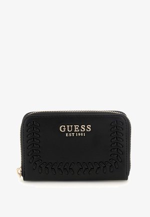 Black leather wallet featuring embossed stitching along the edges, gold-tone hardware, and the "GUESS EST 1981" logo prominently displayed.