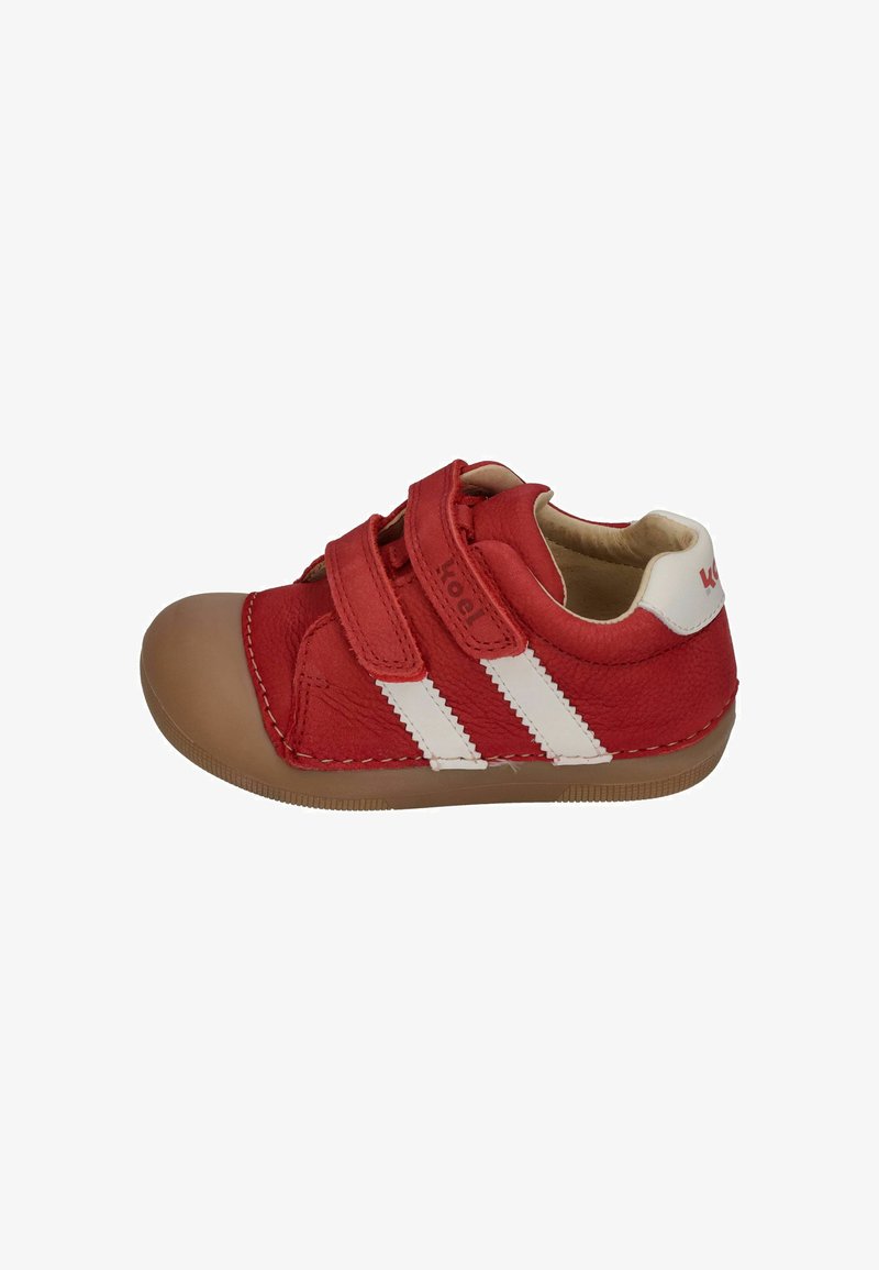 Red leather shoe with two white stripes, rounded toe, and two adjustable Velcro straps. Features a tan rubber sole and stitched accents.