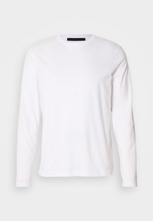 Camiseta de algodón blanca de manga larga con cuello redondo y corte recto. Textura suave y diseño minimalista sin patrones ni acentos visibles.