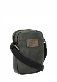 Dunkelgraue Leder-Umhängetasche in rechteckiger Form mit Reißverschluss und einem Schulterriemen aus Stoff. Hat eine strukturierte Oberfläche und ein Patch-Logo.