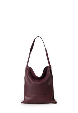 Burgundy leather shoulder bag with a slouchy design, smooth texture, and elongated strap. Features a contrasting bottom half and minimal accents.