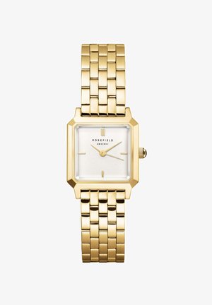 Montre-bracelet en métal doré avec un cadran carré blanc, des indicateurs minimalistes et un bracelet à maillons. Présente une couronne sur le côté droit.