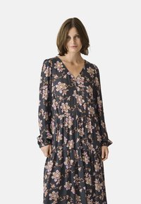 Black floral dress with long sleeves, v-neckline, and tiered design. Features pink and purple floral patterns with elastic cuffs.