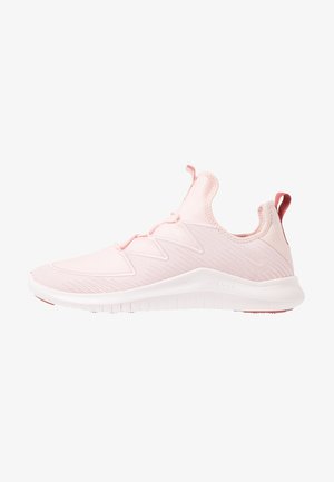 Baskets de sport rose clair avec empeigne texturée, semelle blanche flexible, col rembourré et languettes sur la languette et le talon.