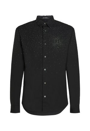 Black long-sleeve shirt with a collar, embellished with silver studs. Features a subtle logo on the left side and button closures.