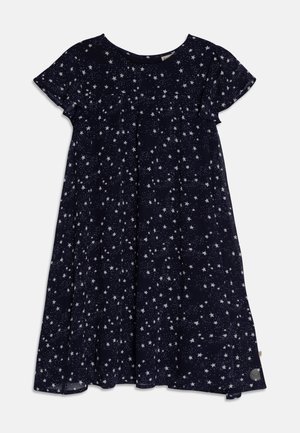 Marineblaues Kleid mit kurzen Ärmeln, rundem Ausschnitt und weißem Sternenmuster. Fließende Form mit Raffungen an der Brust, leichter Stoff.