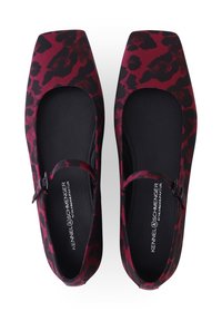 Flache Schuhe mit quadratischer Spitze aus rot-schwarzem Leopardenmusterstoff und schwarzem Innenfutter, mit seitlicher Schnallendetail für sicheren Halt.