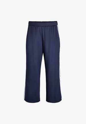 Mornarsko modre športne hlače z elastičnim pasom, z belimi stranskimi črtami in ohlapnim, skrajšanim dizajnom. Gladka tekstura.