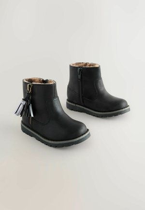 Black ankle boots with a fuzzy lining and a decorative tassel on the side. They feature a zip closure and textured rubber soles.