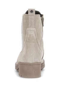 Beige suede ankle boot with a textured back panel and side zipper. Block heel and reinforced stitching detail.