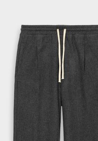 Dark gray sweatpants made of textured fabric, featuring a elastic waistband with a cream-colored drawstring and side pleats.