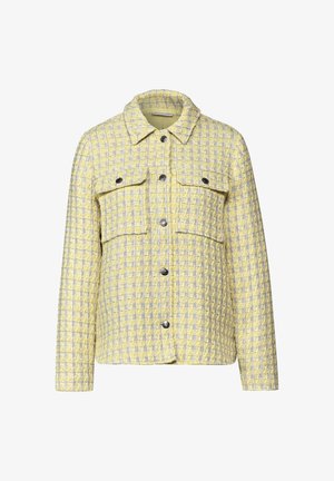 Vadderad jacka i gult och grått med rutmönster. Har en krage, två framfickor och knappstängning. Tyget har en strukturerad yta.