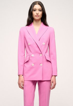 Double-breasted blazer in bright pink wool blend, featuring large front buttons, notched lapels, and side pockets, paired with matching trousers.