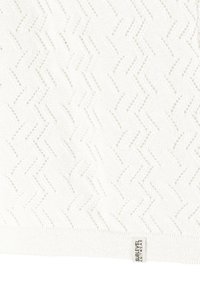 Weißer Strickpullover mit Zickzackmuster, strukturiert mit offenen Maschen und einem gerippten Saum. An dem Etikett steht "Sublevel Knitwear."