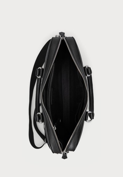 Black leather bag with a structured design, featuring silver hardware and a zip closure. Interior includes multiple compartments and a fabric lining.