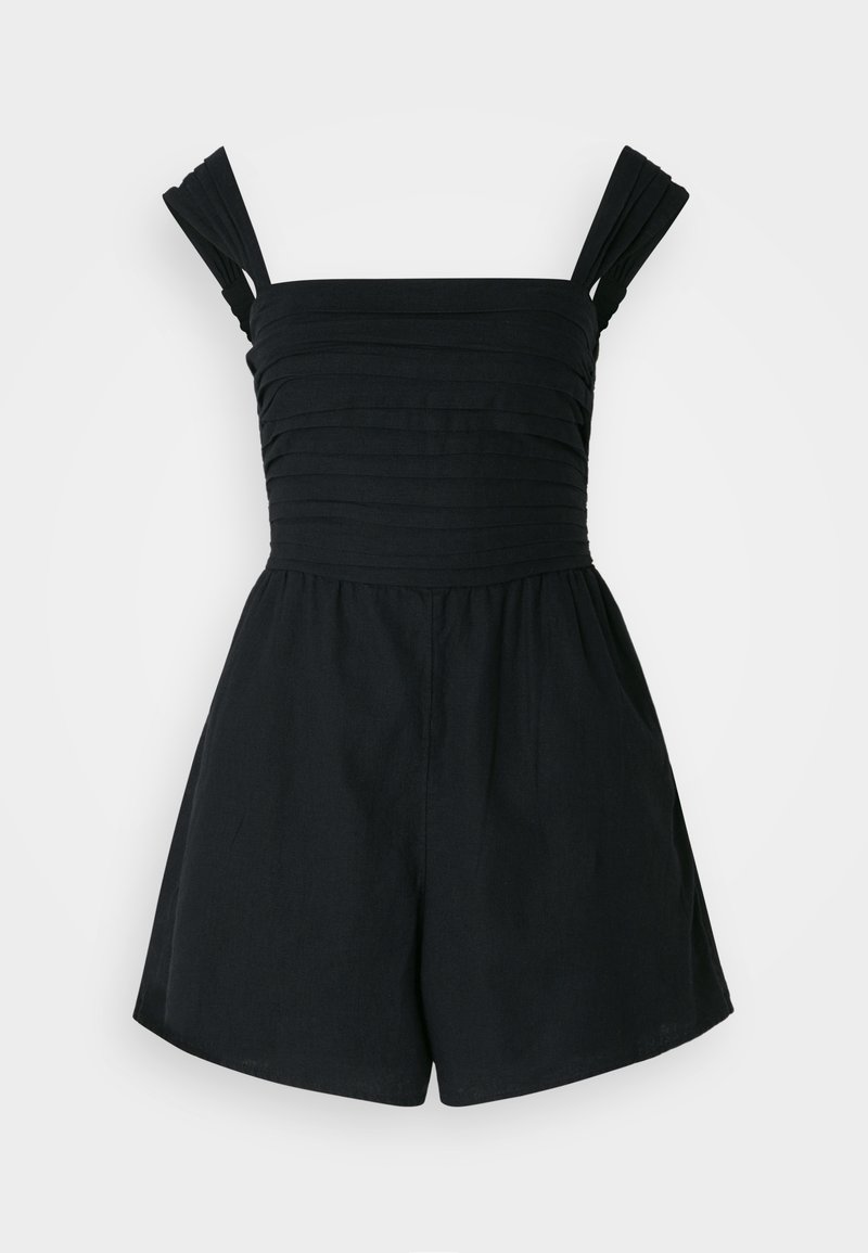 Black romper with pleated, wide shoulder straps, fitted bodice, and loose shorts. Made from lightweight fabric with a smooth texture.