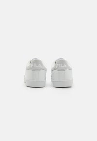 Sneakers bianchi FILA con tomaia in pelle liscia, punta tonda e collo imbottito. Presentano il logo impresso sul tallone e suola in gomma piatta.