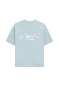 Light blue cotton t-shirt with short sleeves. "Prohibited" and "10119 BERLIN" printed in white cursive and block fonts on the back.