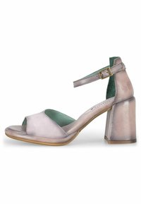 Open-toe heeled sandal in soft lavender leather with ankle strap, rounded upper, and chunky heel. Light blue-green insole. Smooth texture.