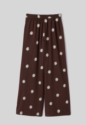 Pantalon marron à jambes larges avec une taille élastique, décoré de petits motifs blancs dispersés en forme de soleil.