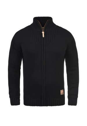 Black zip-up sweater made of textured knit fabric, featuring a high collar, ribbed cuffs and hem, and a leather logo patch at the bottom.