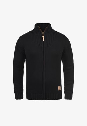 Black zip-up sweater made of textured knit fabric, featuring a high collar, ribbed cuffs and hem, and a leather logo patch at the bottom.