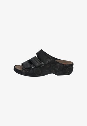 Black open-toe sandal with floral texture, three adjustable Velcro straps, cushioned insole, and a low, contoured heel.