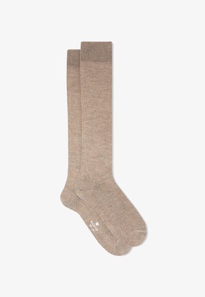 Beige knee-high socks with a soft knit texture, contrasting ribbed cuff at the top, and a smooth, seamless footbed.