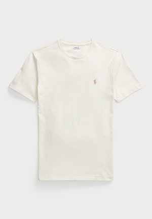 Cream short-sleeve T-shirt made of cotton. Features a round neckline and a small, embroidered logo on the left chest. Smooth texture.