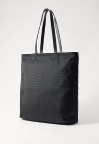 Black tote bag with textured nylon fabric, dual flat handles, and a rectangular shape. Seamless design, no visible accents or hardware.