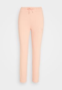 Lichtroze trainingsbroek met elastische tailleband en cuffs, trekkoord en subtiel reliëflogo op het bovenste deel van het linkerdij.