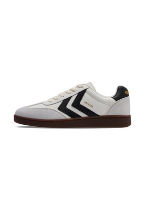 White sneaker with black chevron stripes, beige suede toe, brown sole, and "VM78 CPH" text on the side.