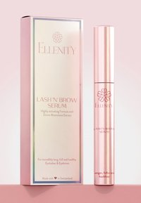 Lash 'N' Brow Serum in a metallic pink tube, placed beside a pink box with a white reflective panel and soft text on the front.