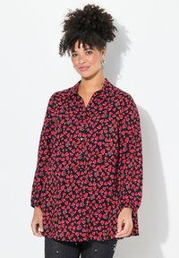 Rot- und schwarz karierte Hemdbluse mit einem Blattmuster, langen Ärmeln und einem Kragen. Weicher Stoff, lockere Passform, mittellang.