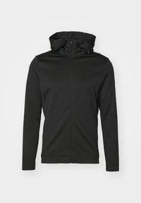 Sweat à capuche noir zippé avec un col haut, des manches longues et des coutures latérales. Tissu lisse et flexible avec des coutures minimales et aucun élément métallique visible.