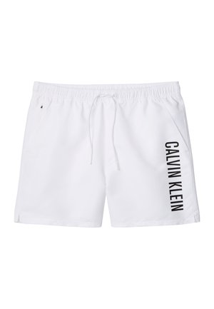 Costume da bagno da uomo bianco con vita elasticizzata, coulisse, tasche laterali e la scritta "CALVIN KLEIN" stampata verticalmente sulla gamba destra.