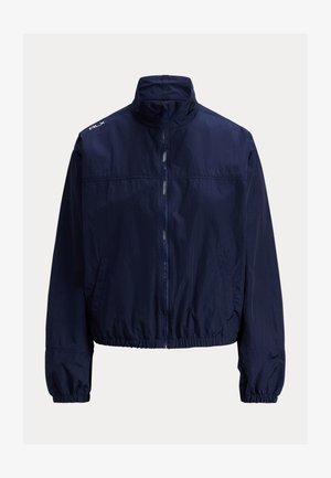 Tengerészkék szélálló dzseki magas gallérral, elől cipzáras záródással, rugalmas mandzsettákkal és oldalzsebekkel. Könnyű, texturált anyag.