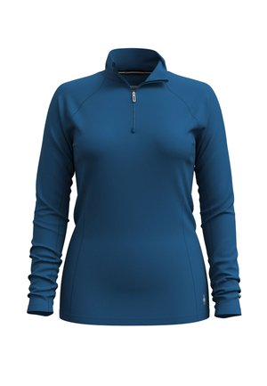 Sudadera de manga larga con cuello de cremallera en azul profundo, hecha de material suave. Presenta un diseño ajustado con detalles de costura sutiles y mangas enrollables.
