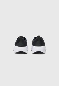 Black athletic shoes with a sleek design, featuring a textured upper and white soles, accented by a black heel tab and logo.