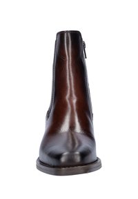 Bruine leren enkelboot met een gladde afwerking, zijrits en een ronde neus. Stevige zool met een lichte verhoging.