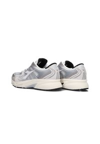 Scarpe da atletica grigie con una tomaia in mesh, dettagli testurizzati e una suola ammortizzata con un rivestimento interno nero a contrasto.