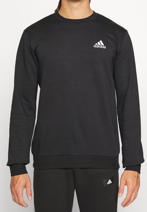 Schwarzes Sweatshirt mit Rundhalsausschnitt aus Baumwollmischgewebe. Mit weißem Logo auf der linken Brust sowie gerippten Bündchen und Saum.