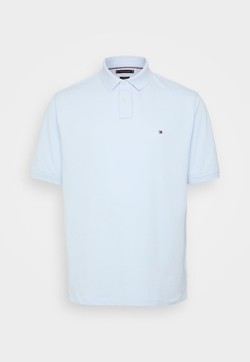 Light blue short-sleeve polo shirt made of soft cotton. Features a classic collar and a small logo on the left chest. Row of buttons at neck.