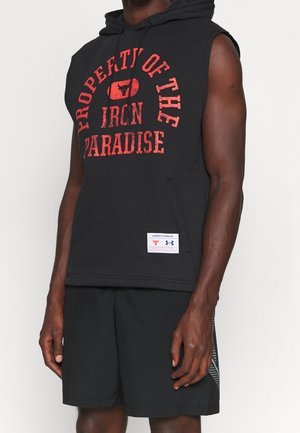 Black sleeveless hoodie with red text "PROPERTY OF THE IRON PARADISE" and front pocket. Paired with black shorts featuring a textured side panel.