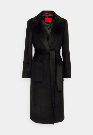 Long black coat made of soft fabric, featuring a wide collar, front pockets, a belted waist, and a smooth lining.