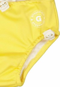 Keltainen uimisideo, jossa on teksturoitu pinta. Varustettu valkoisella logolla ja nappisuljennalla. Joustavat reunat varmistavat tukevan istuvuuden.