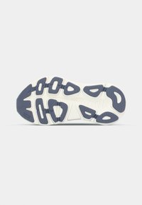 Shoe sole with a white base and navy blue traction pattern. Features rounded shapes and grooves for grip and flexibility. Textured texture.